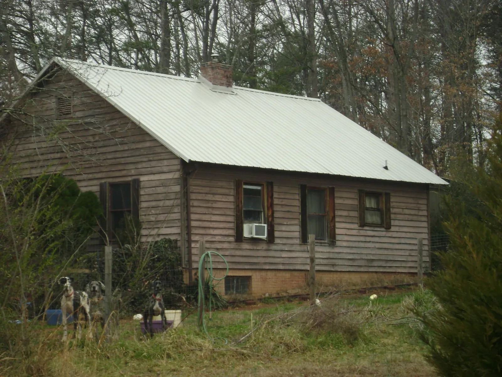 White metal roof on an old wood sided farmhouse, from a Metal Roof Installation job in Fair Play